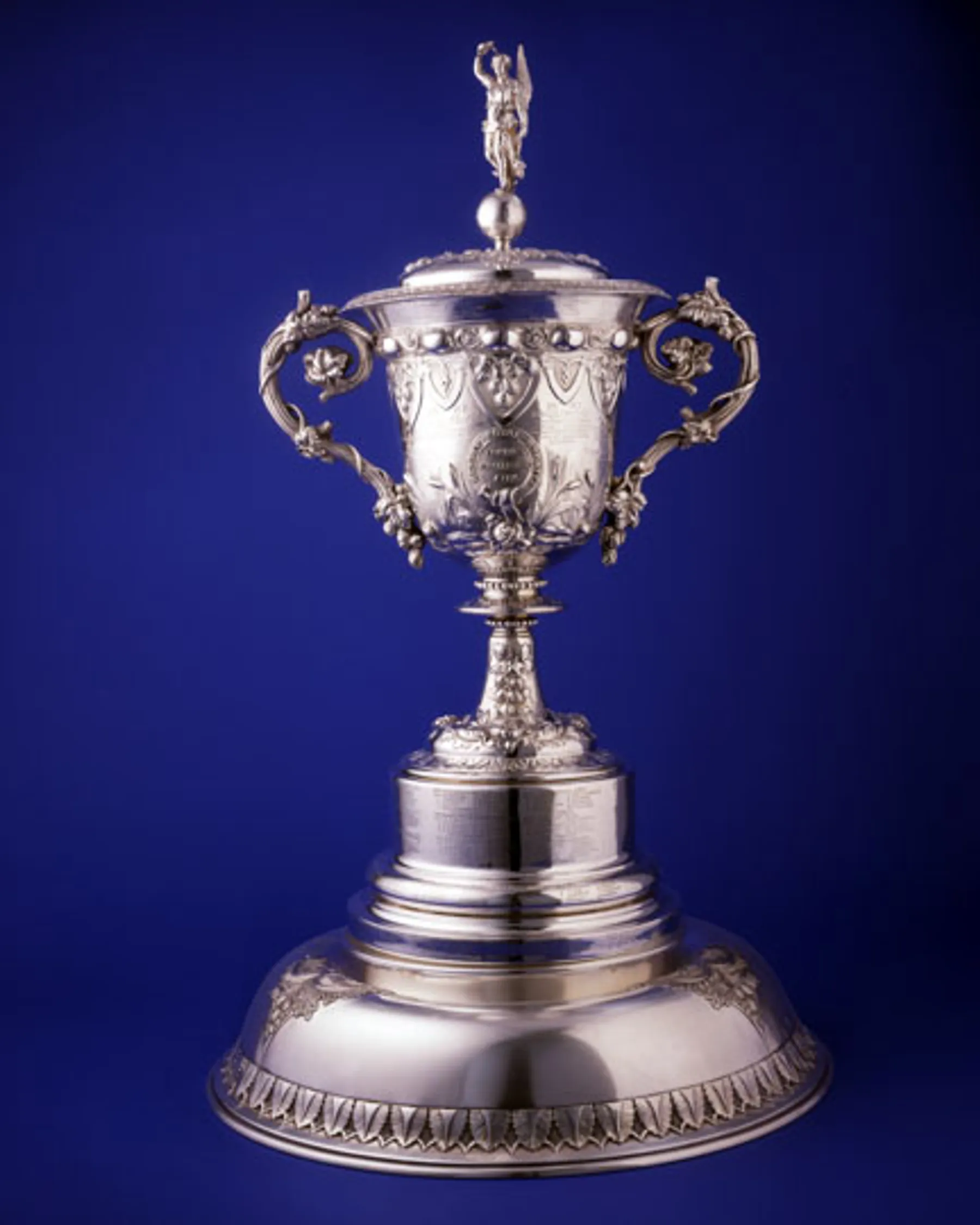 The Thames Challenge Cup — an ornate Victorian silver trophy with elaborate handles and a figurine on top